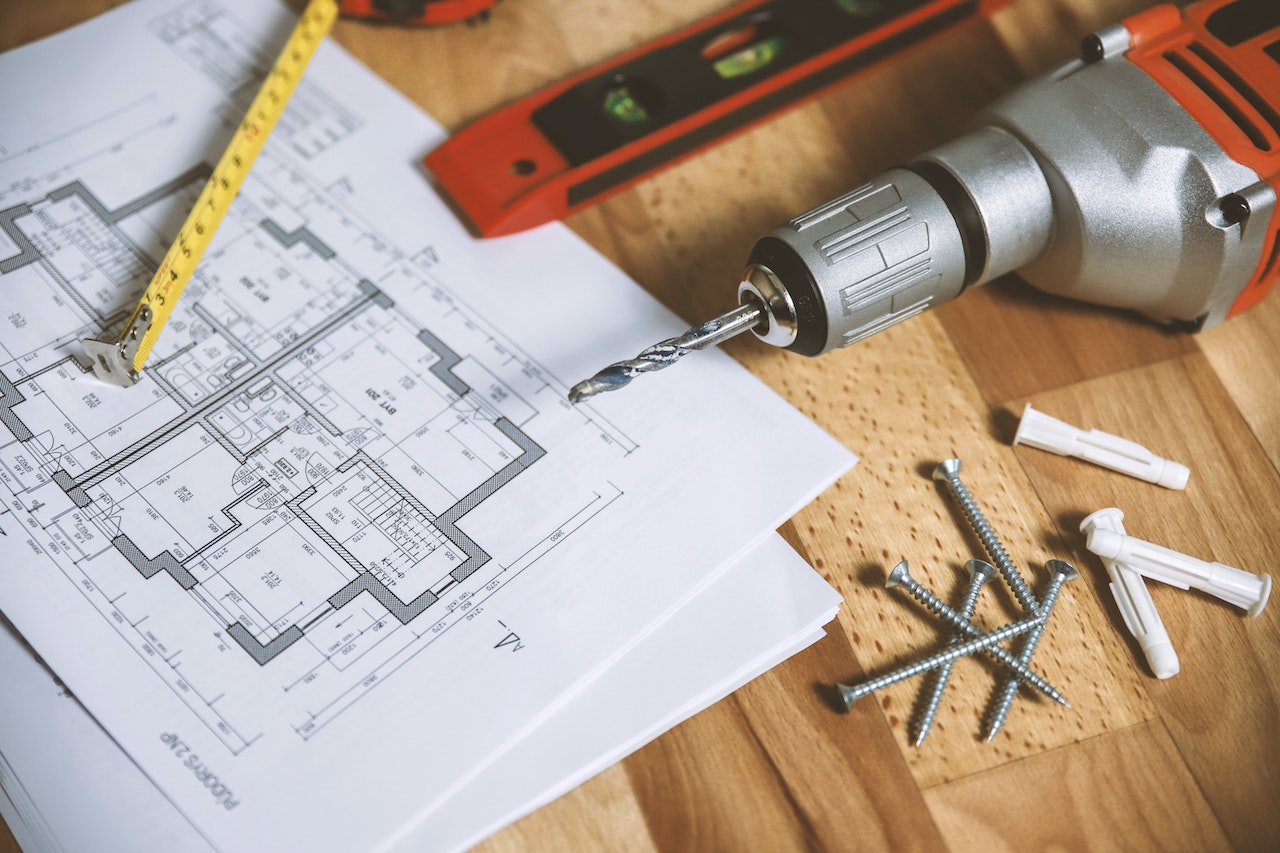 Architect drawing, tape measure and drill