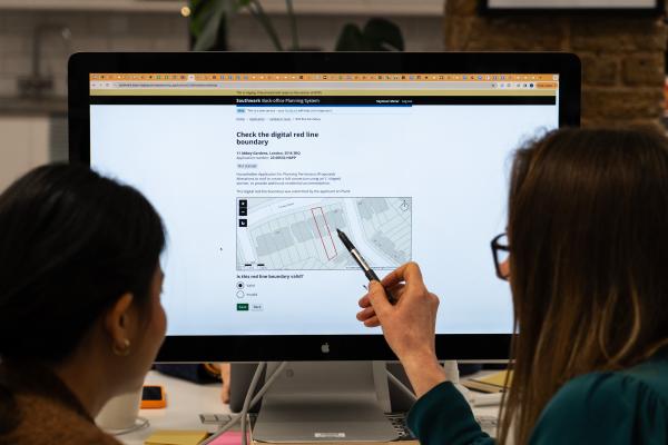 Two females looking at an onscreen site plan